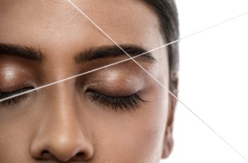 Close-up,Of,Indian,Woman,Face,With,A,Thread.,Eyebrow,Threading